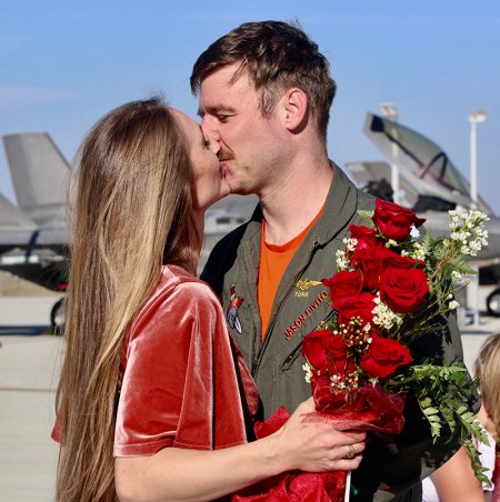 Photo Gallery: Family and U.S. Navy officials greet return of NAS Lemoore F-35 aviators to Lemoore from first sea deployment Hollie Devito kisses her husband Jason Devito